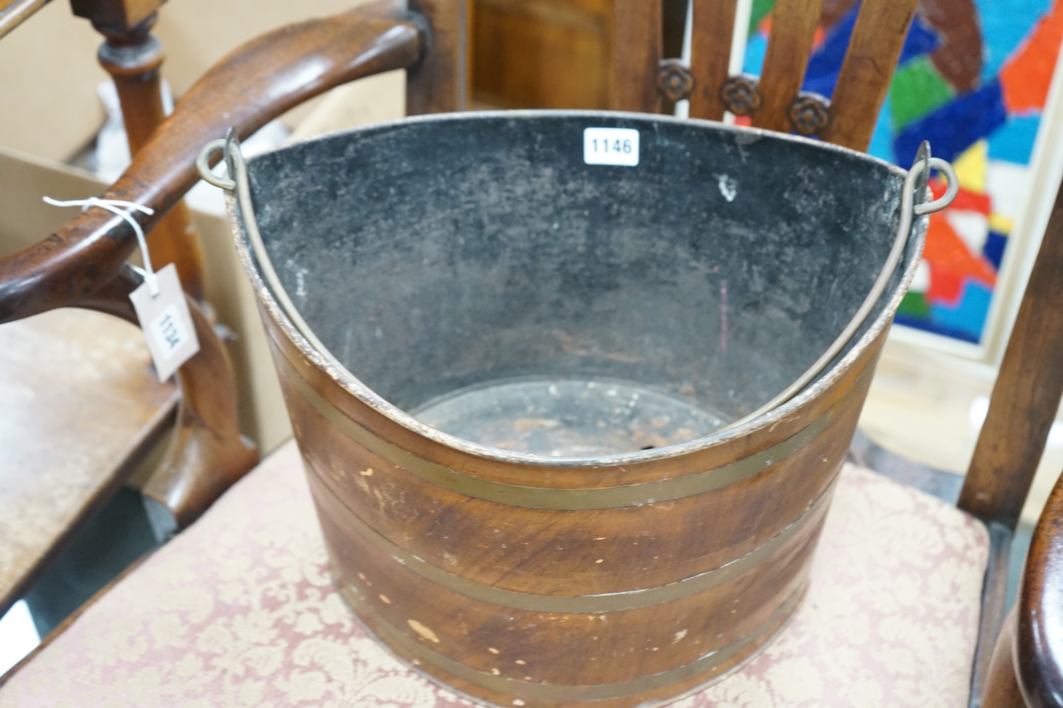 A Regency Toleware bucket with simulated mahogany and brass effect